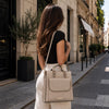 Over The Shoulder View Of Woman Posing With The Light Taupe Backpack Handbag