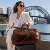 Woman in sunglasses with Large Leather Trolley Bag by the Sydney Harbour.