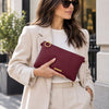 Woman Holding The Bordeaux Clutch