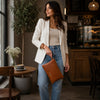 Woman Holding The Cognac Clutch By  The Strap