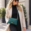 Woman Wearing The Teal Clutch As A Crossbody Bag