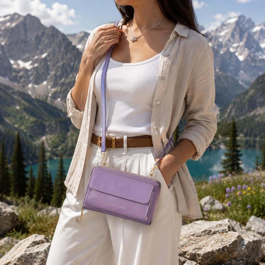 Woman wearing a lilac leather crossbody phone wallet outdoors