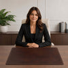 Woman sitting at a desk with the Leather Desk Pad, styled for a professional office environment.