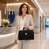 Stylish woman in a suit holding the Leather Doctors Bag in a modern office environment.