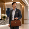 Stylish man holding the Doctors Bag, showcasing Italian leather craftsmanship in a modern office setting.