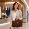 Woman in a beige suit carrying the Doctors Bag in a modern office lobby.