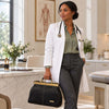 Woman in a doctor's coat holding a Doctors Bag, showcasing style and practicality in a professional setting.