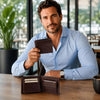 Mens Leather Wallet displayed by a man in a blue shirt, showcasing its compartments and sleek design.
