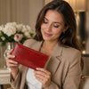 Woman holding a stylish red Womens Leather Wallet, showcasing its elegance and full grain leather design.