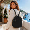 Woman wearing Genuine Leather Backpack in a scenic outdoor setting.