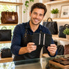 Man showcasing Leather Card Holder with multiple credit card pockets in a stylish shop.