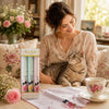 Hankies Box Of 3 Cats Design displayed with a woman and a cat, elegant handkerchiefs on a floral table setting.