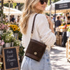 Woman In A Market Wearing The  Beige Italian Leather Crossbody Bag Over Her Shoulder 