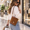 Woman In A Shopping Centre Wearing The  Cognac Italian Leather Crossbody Bag Over Her Shoulder 