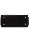 An underneath view of the Black pebbled Italian leather duffle bag shown from the bottom front view, featuring four gold-tone metal studs on the corners