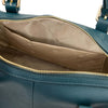 Close-up of the interior of a Teal Italian leather duffle bag, showing a beige patterned lining, open pocket and gold-tone hardware.