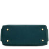An underneath view of the Teal pebbled Italian leather duffle bag shown from the bottom front view, featuring four gold-tone metal studs on the corners