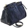 Angled And Shoulder Strap View Of The Dark Blue Italian Suede Drawstring Shoulder Bag