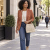 Woman In The Street Wearing The Beige Italian Suede Leather Bucket Bag As A Crossbody Bag