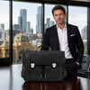 Italian Leather Briefcase displayed by a man in a business suit in a modern office setting with city skyline view.