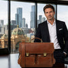 Italian Leather Briefcase on a table with a professional man in a suit and a city skyline in the background.