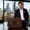A professional man in a suit standing with a Italian Leather Briefcase in a city office.