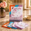 Ladies Scalloped Edge Handkerchiefs 10 Pack featuring floral designs in vibrant colors, displayed in a clear package.