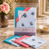 Ladies Scalloped Edge Handkerchiefs 10 Pack displayed in a clear package with floral designs and scalloped edges.