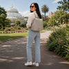 Stylish woman wearing the Ladies Backpack in a lush park setting, perfect for commuting or city exploration.