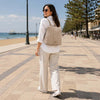 Model wearing the Ladies Backpack on a sunny beachside promenade, showcasing a stylish and functional ladies backpack.