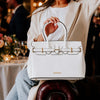 Stylish Ladies Handbag in white, perfect for the contemporary woman, showcased at a chic event.