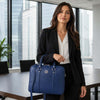 A businesswoman carrying a Ladies Leather Laptop Case in a modern office setting.