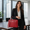 Professional woman in a black suit carrying a Ladies Leather Laptop Case in red.