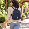 Woman Walking in the street with the Dark Blue Ladies Small Leather Backpack