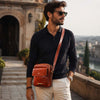 Mens Crossbody Bag worn by a man in stylish attire outdoors, showcasing its modern design and functionality.