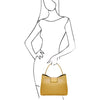 Woman Posing With The Pastel Yellow Leather Handbag For Women