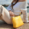 Women Posing With The Pastel Yellow Leather Ladies Handbag