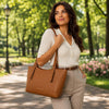 Woman wearing a Genuine Leather Shoulder Bag for Women in a park setting, showcasing timeless style and practicality.
