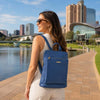 Leather Backpack Ladies in denim, worn by a woman on a scenic pathway by the water.