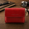 Leather Card Holder in premium red full grain leather on a wooden surface.