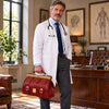 Man in a doctor's coat holding a Italian Leather Doctors Bag in a classic office setting.