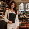 Woman holding Leather Document Case With Ring Binder in a stylish store setting.