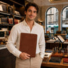 Young man holding a Leather Document Case With Ring Binder in a stylish stationery store.