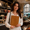Woman holding a natural Leather Document Case With Ring Binder in a stylish store setting.