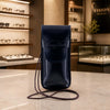 Leather Eyeglasses Case displayed on a marble table in a stylish optical store interior.