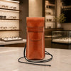 Leather Eyeglasses Case displayed on a table with a stylish background, showcasing its full grain leather and detachable strap.