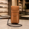 Leather Eyeglasses Case displayed elegantly in a retail setting with a stylish design and detachable shoulder strap.