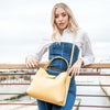 Woman Posing With The Pastel Yellow Leather Handbag For Women