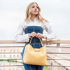 Woman Holding The Pastel Yellow Leather Handbag For Women