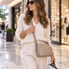 Beautiful Woman In A Shopping Centre With The Light Taupe Leather Ladies Handbag